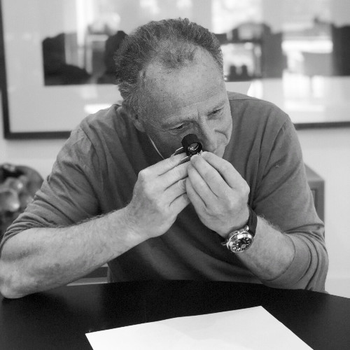 Michel Beller examining a stone through a loupe