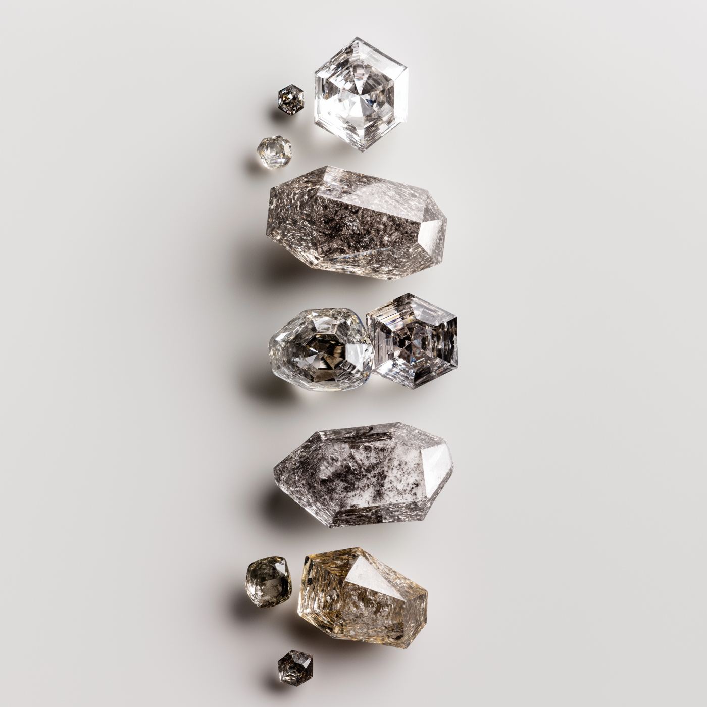 A vertical composition of rough and polished diamond crystals