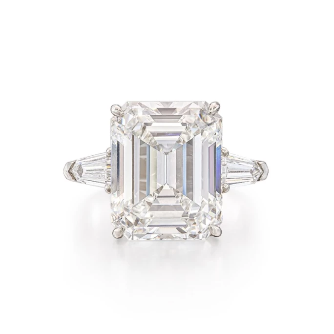An emerald-cut diamond engagement ring in yellow gold