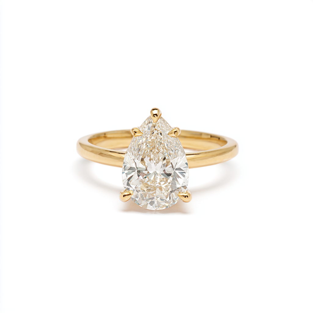 A pear-cut diamond solitaire engagement ring on a finger